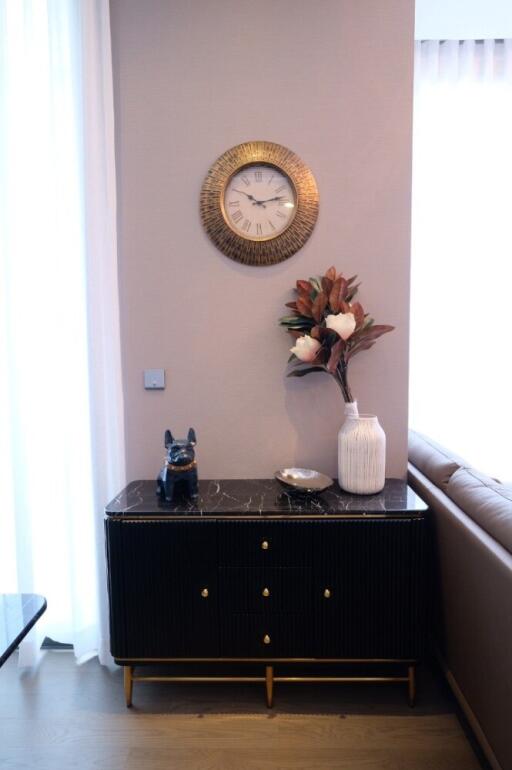 Elegant corner with a small black cabinet and decorative items