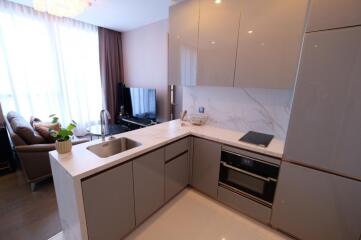 Modern kitchen with integrated appliances and adjacent living area