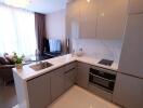 Modern kitchen with integrated appliances and adjacent living area