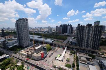 Aerial view of a city with high-rise buildings, roads, and construction sites