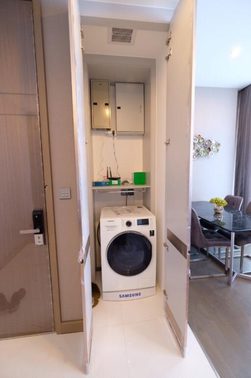 Laundry area with Samsung washing machine in a cupboard