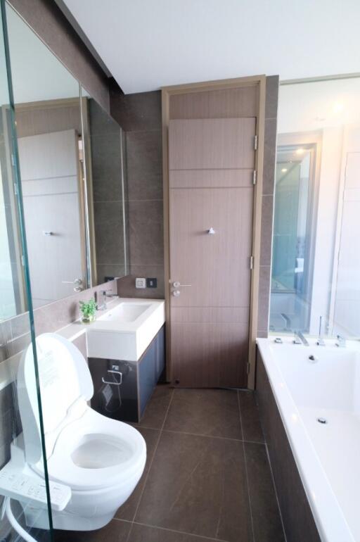 Modern bathroom with sink, toilet, and glass shower enclosure