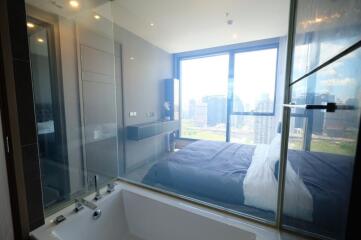 Modern bedroom with large windows and city view