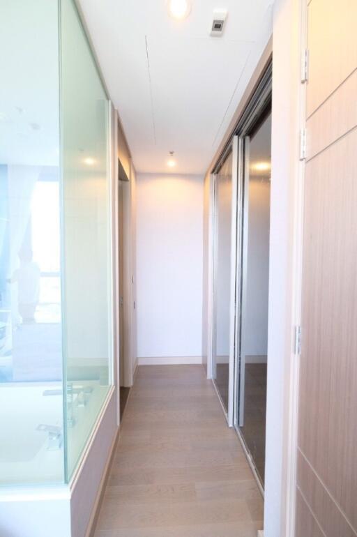 Modern hallway with glass wall and wooden flooring