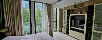 Spacious bedroom with large windows and built-in entertainment unit