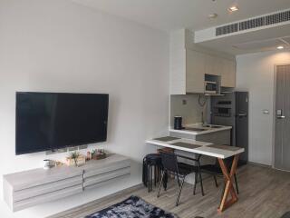 Modern living area with TV and compact kitchen