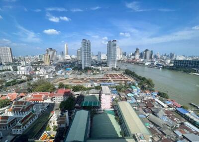 Aerial view of a city with high rise buildings and a river