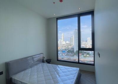 Bedroom with large window and city view