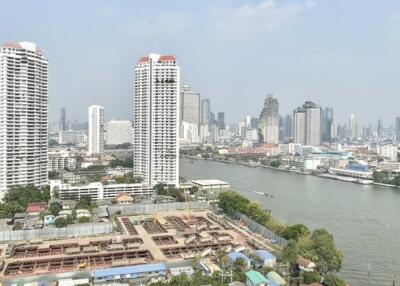 View of cityscape with river and tall buildings