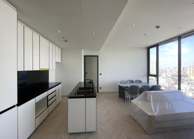 Modern open-plan kitchen and living area with city view