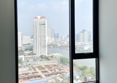 Bedroom with large window and city view