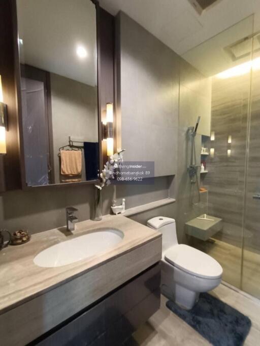 Modern bathroom with glass shower and a large mirror