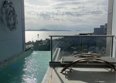 Balcony with a pool and ocean view