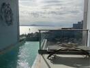 Balcony with a pool and ocean view