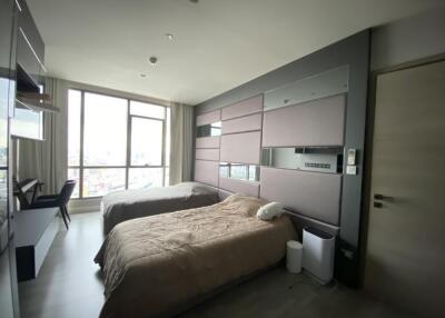 Modern bedroom with two beds and large windows