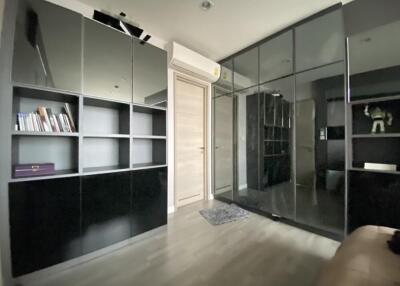 Modern bedroom with black cabinetry and mirrored closet doors