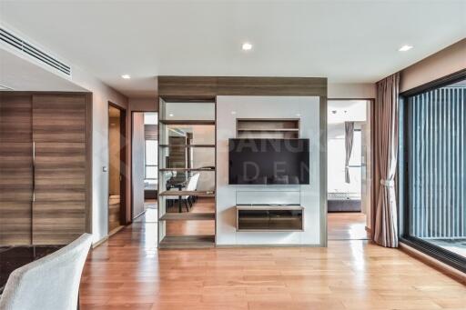 Modern living room with wooden flooring and large windows