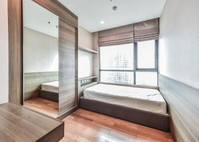 Modern bedroom with large windows and wooden furniture