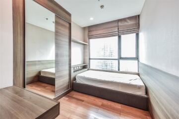 Modern bedroom with large windows and wooden furniture