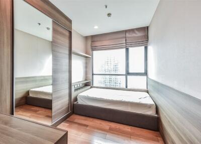 Modern bedroom with wooden floor and large window