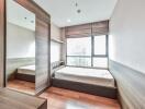 Modern bedroom with wooden floor and large window