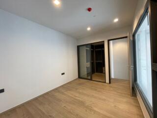 Modern bedroom with wooden floors and recessed lighting