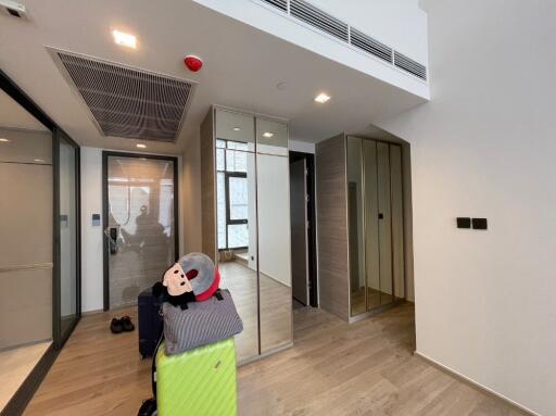 Modern hallway with luggage and mirrors