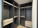 Spacious walk-in closet with built-in shelves and drawers