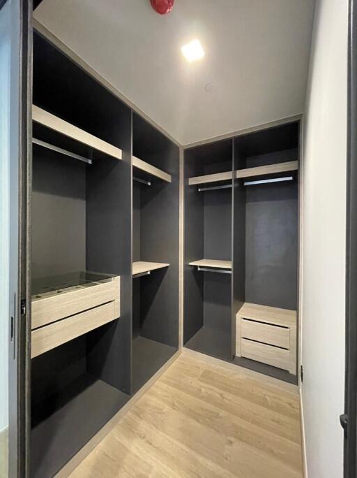 Spacious walk-in closet with built-in shelves and drawers