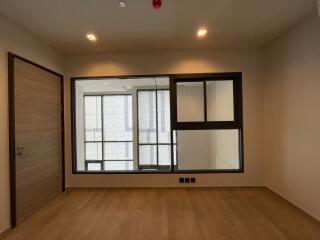 Empty room with wooden floor and large window