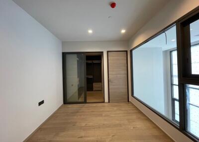 Spacious bedroom with wooden flooring and built-in closet