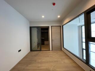 Spacious bedroom with wooden flooring and built-in closet