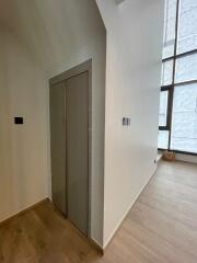 Corner view of a modern living area with large windows and wooden flooring