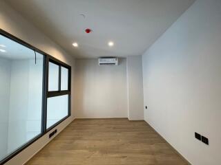 Modern bedroom with hardwood flooring and large windows