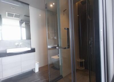 Modern bathroom with glass-enclosed shower and vanity