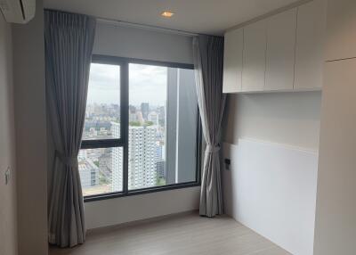 Bedroom with large window and city view