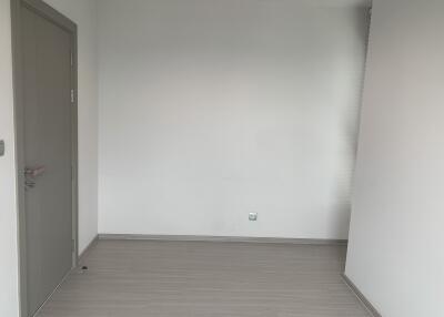 Empty room with closed door and walls painted white