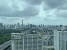 Cityscape view with high-rise buildings under cloudy sky