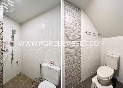 Modern tiled bathroom with toilet and shower area