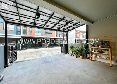 Well-lit garage space with shelving and potted plants