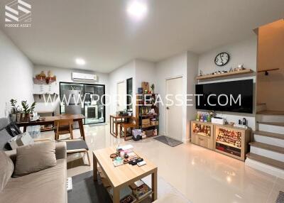 Living room with dining area and staircase