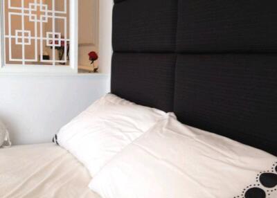 Cozy bedroom with decorative pillows and a modern headboard