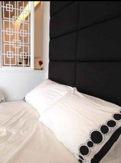 Cozy bedroom with decorative pillows and a modern headboard