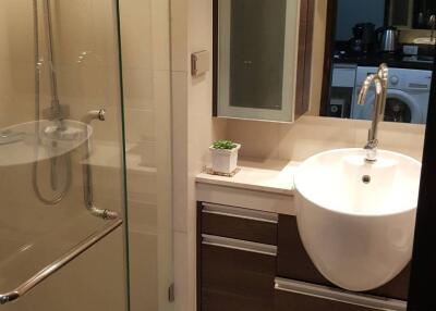 Modern bathroom with glass shower partition and vanity