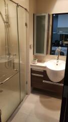 Modern bathroom with glass shower partition and vanity