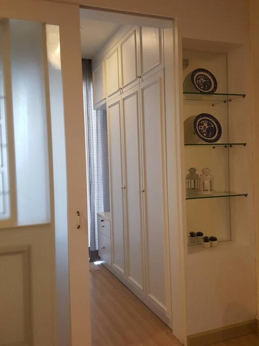 Well-organized hallway with built-in storage and decor