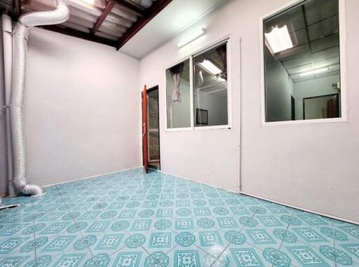 Room with blue patterned floor tiles and glass windows