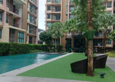 Outdoor communal area with swimming pool and greenery