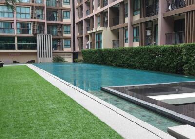 Swimming pool area with buildings in the background