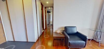 Living room with a black armchair and wooden flooring